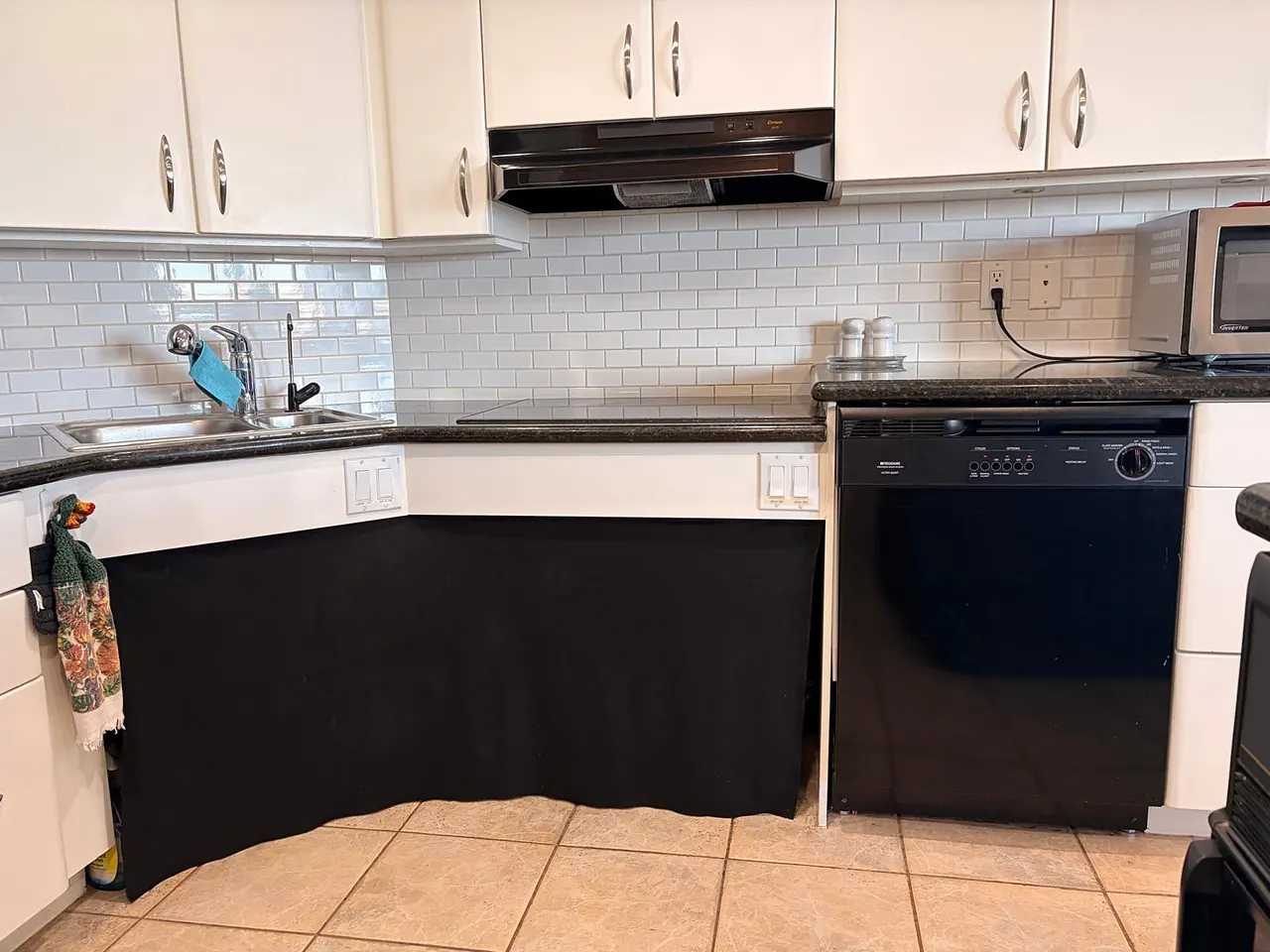 Lowered kitchen sink counter beside the dishwasher, with knee space behind a fabric skirt